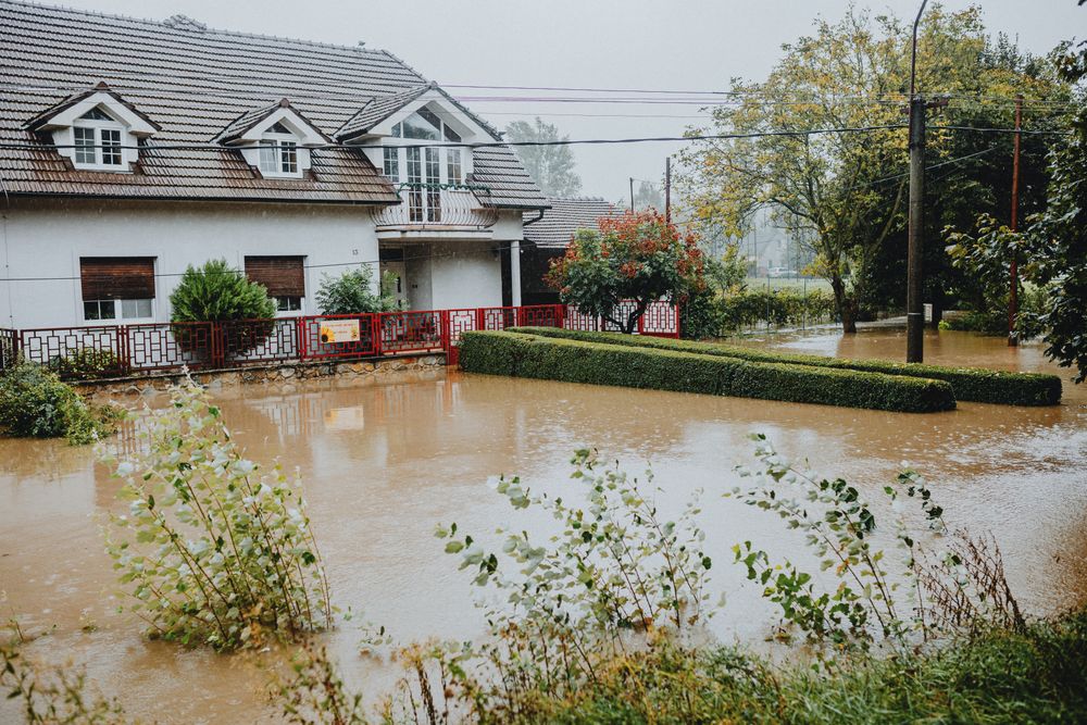 A suburban house surrounded by floodwater after heavy rain