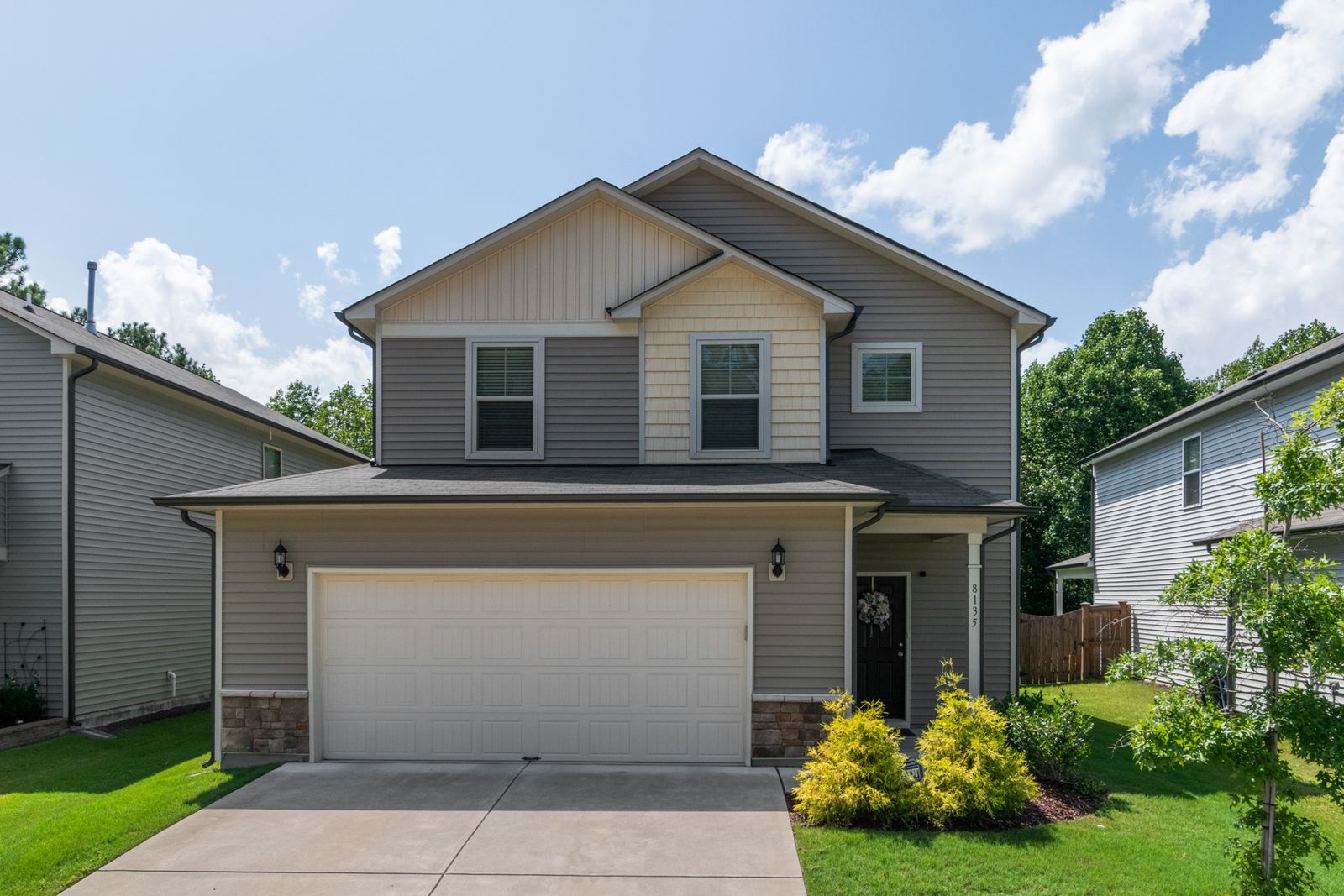 The front of a suburban family home with a landscaped lawn